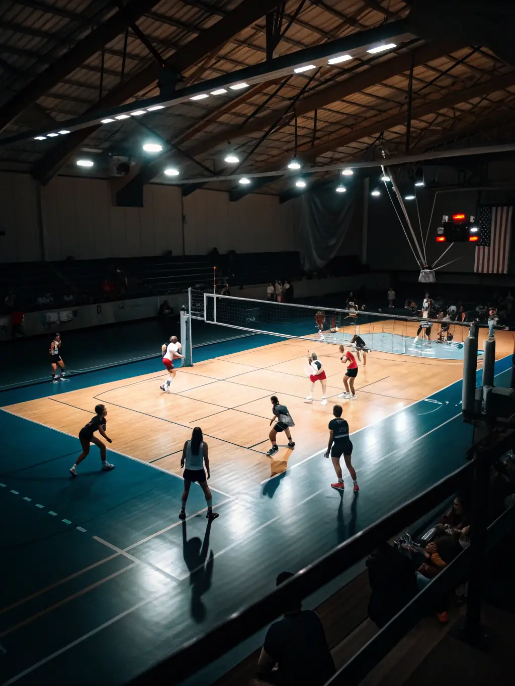 Image of a volleyball tournament organized by the COMITE DEPARTEMENT CHARENTE VOLLEY BALL, showcasing competitive play and community involvement, with spectators cheering in the background.